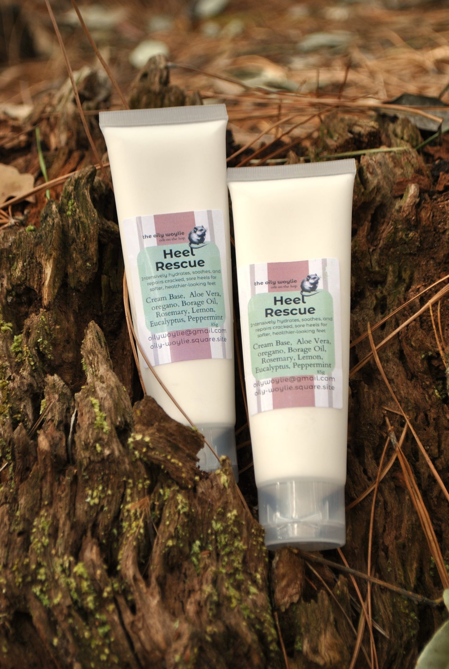Two tubes of 'Heel Rescue' cream on a wooden surface with natural background