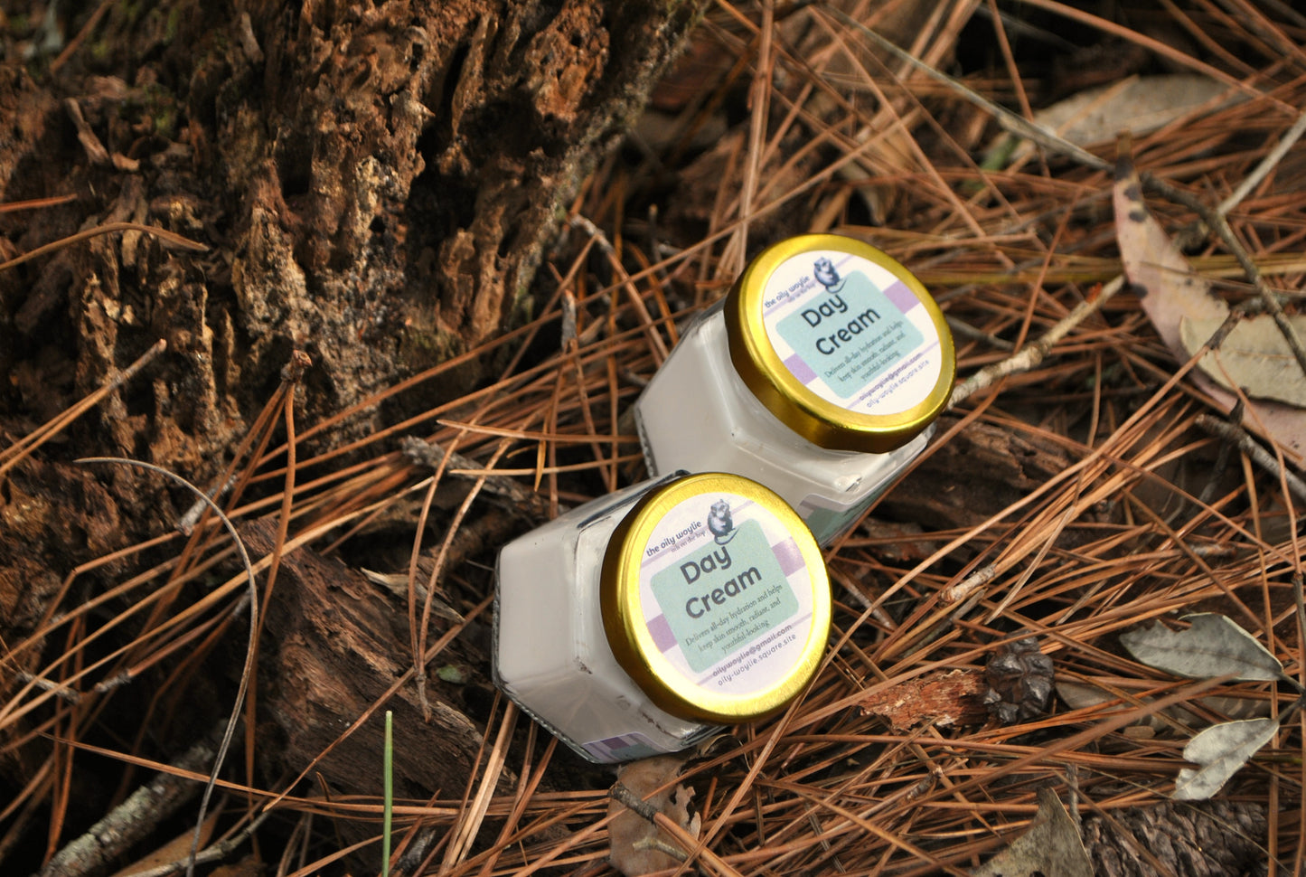 Two jars of 'Dog Cream' on a natural background with pine needles and wood.