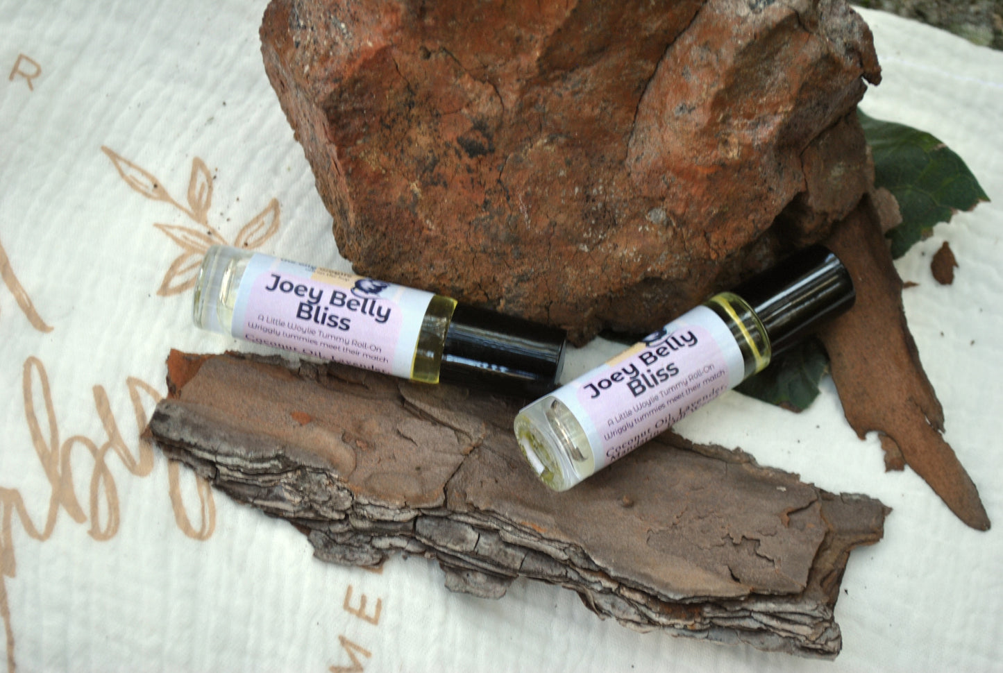 Joey Belly Bliss products on a natural background with rocks and leaves