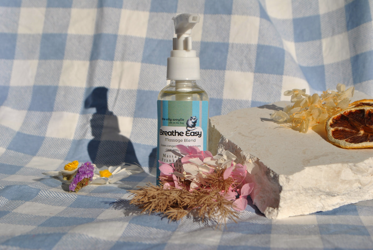 Breathe Easy Massage Blend essential oil bottle, natural massage oil to support clear breathing on a checkered background