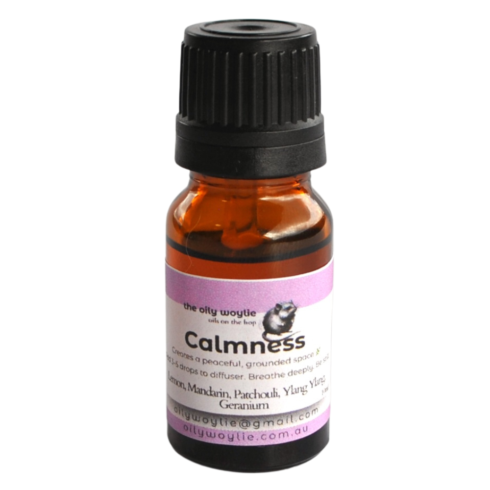 Small amber bottle of calmness diffuser oil on a white background