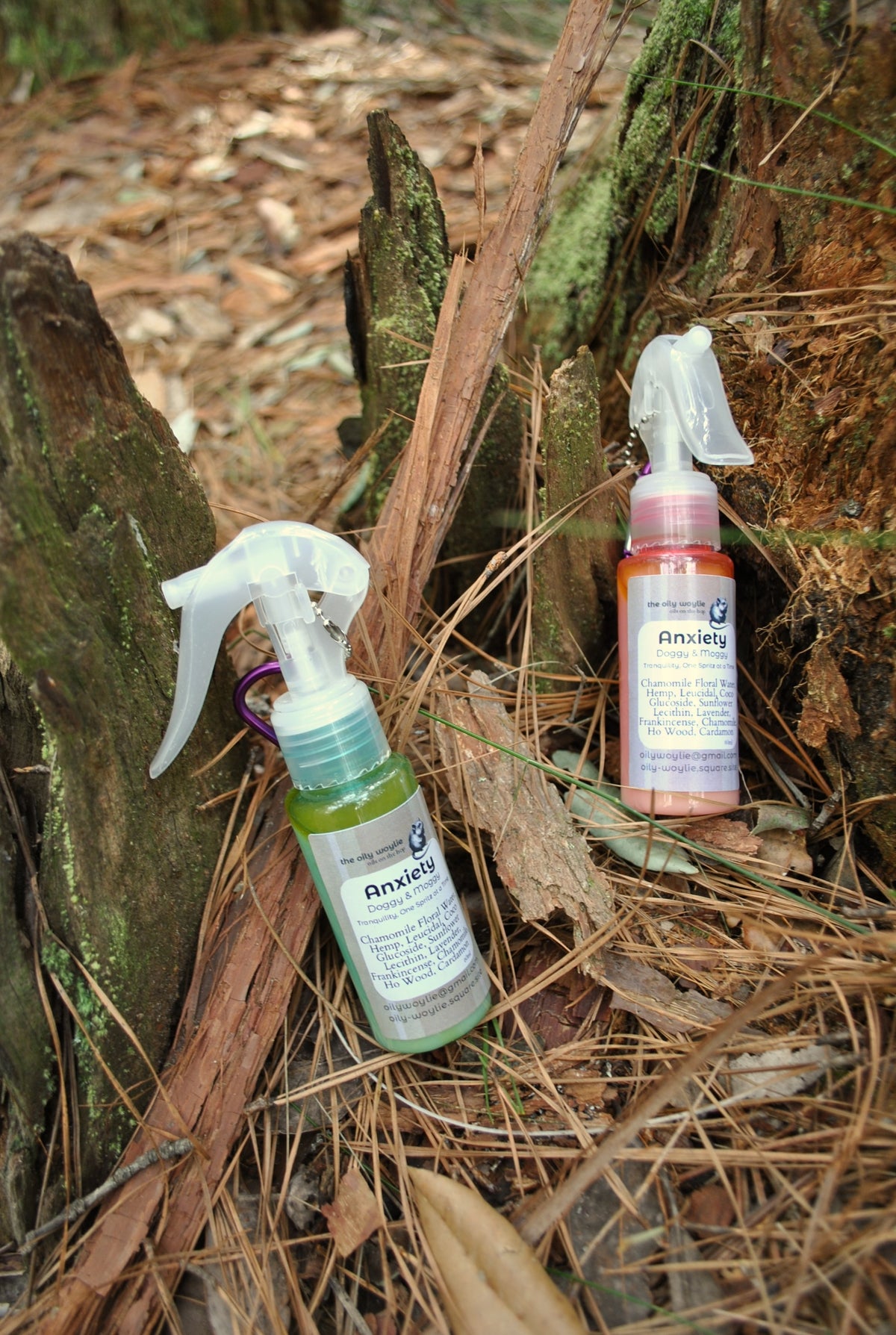 Doggy & Moggy Anxiety Blend spray bottle, natural calming spray for pets on a forest floor with leaves and branches.
