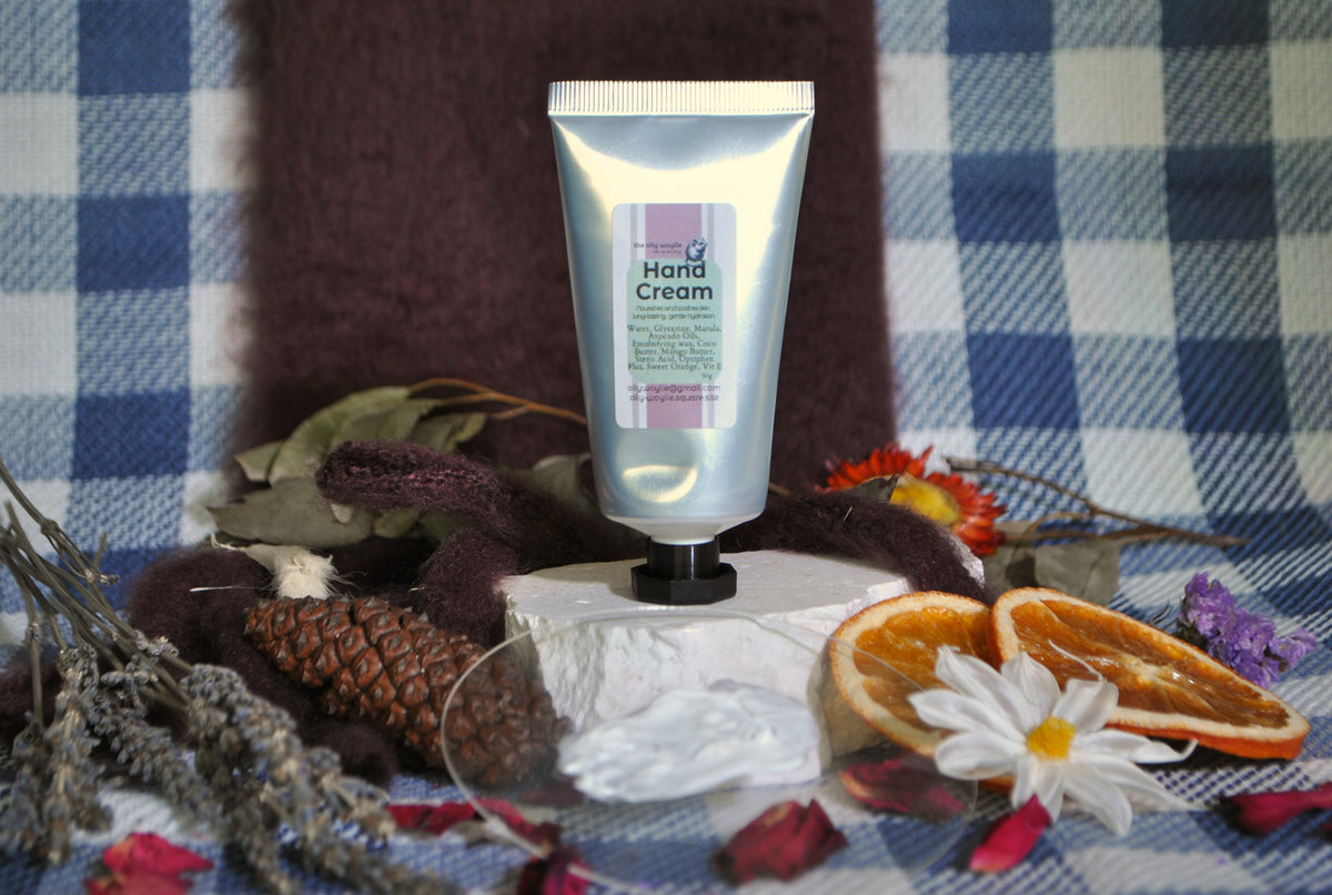 Hand Cream tube, natural moisturising cream for soft and nourished hands with dried flowers and oranges on a checkered fabric background