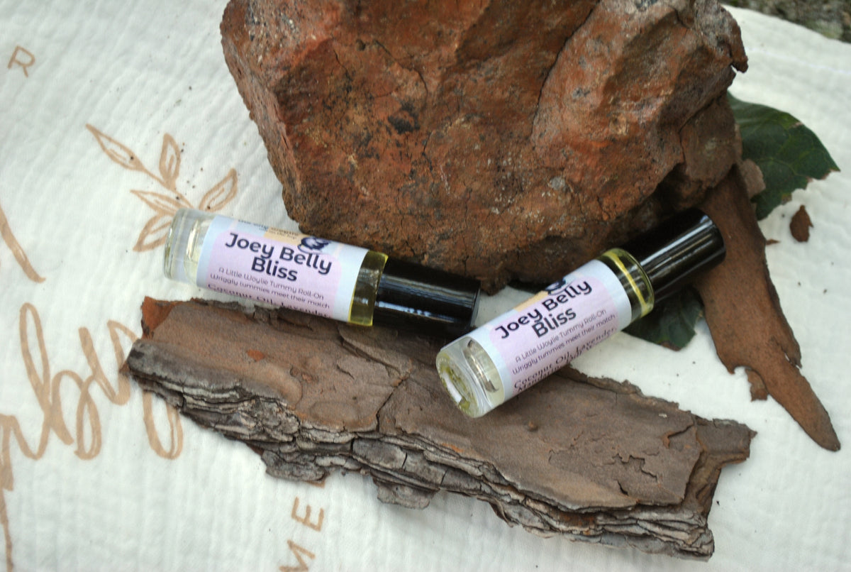 Joey Belly Bliss essential oil blend in a roller bottle, natural tummy support for kids In Aussie bush