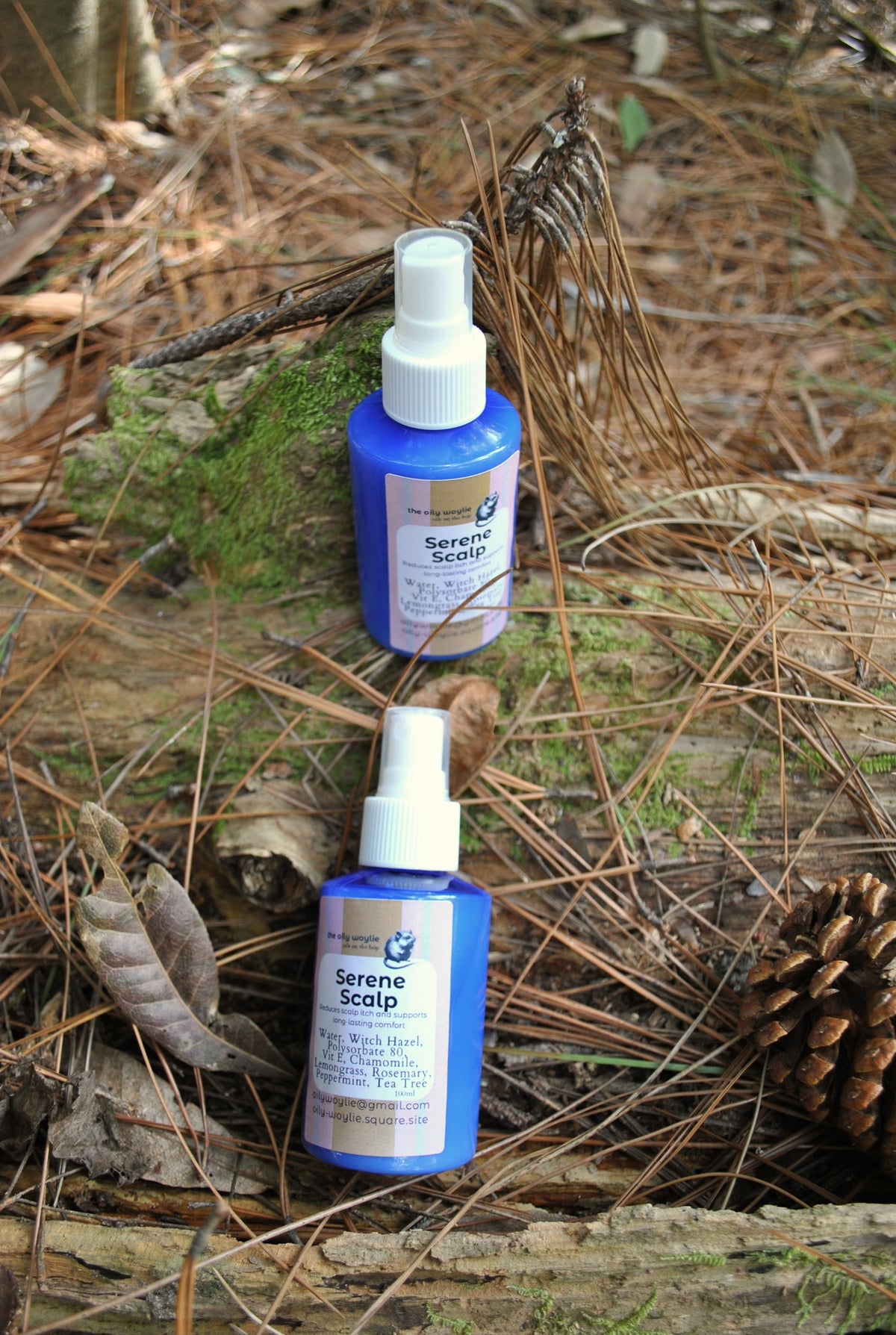 Serene Scalp treatment bottle, natural scalp care oil on a natural background with pine needles and leaves.