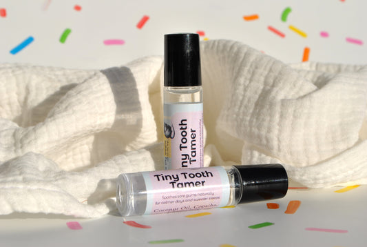 Tiny Tooth Tamer essential oil blend in a small bottle, natural relief for teething discomfort on confetti background