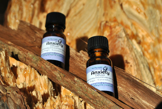 Two bottles labeled 'Anxiety' on a wooden surface