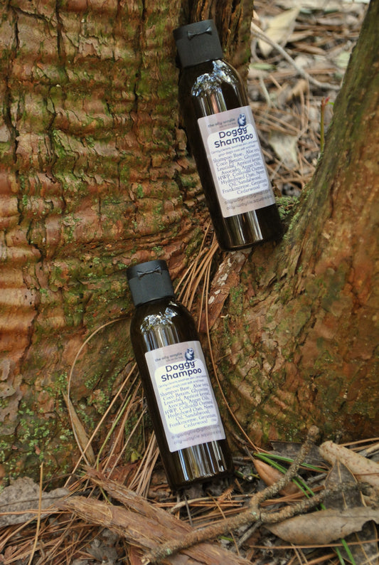 Two bottles of dog shampoo on a tree trunk with natural background