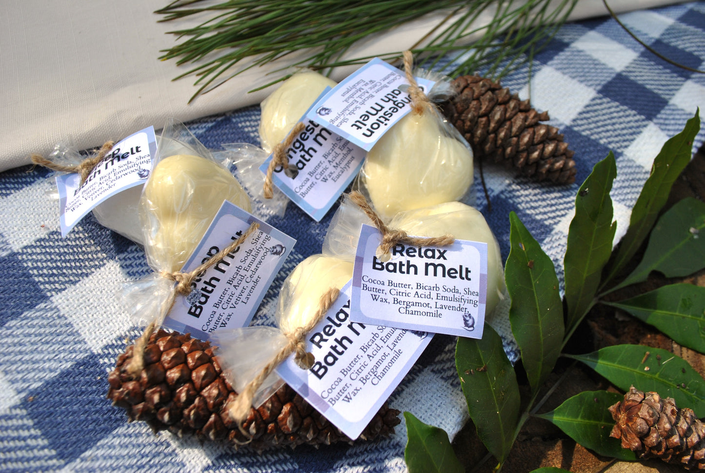 Bath Melt family collection – Relax, Sleep, and Congestion natural essential oil bath melts and pinecones on a checkered cloth