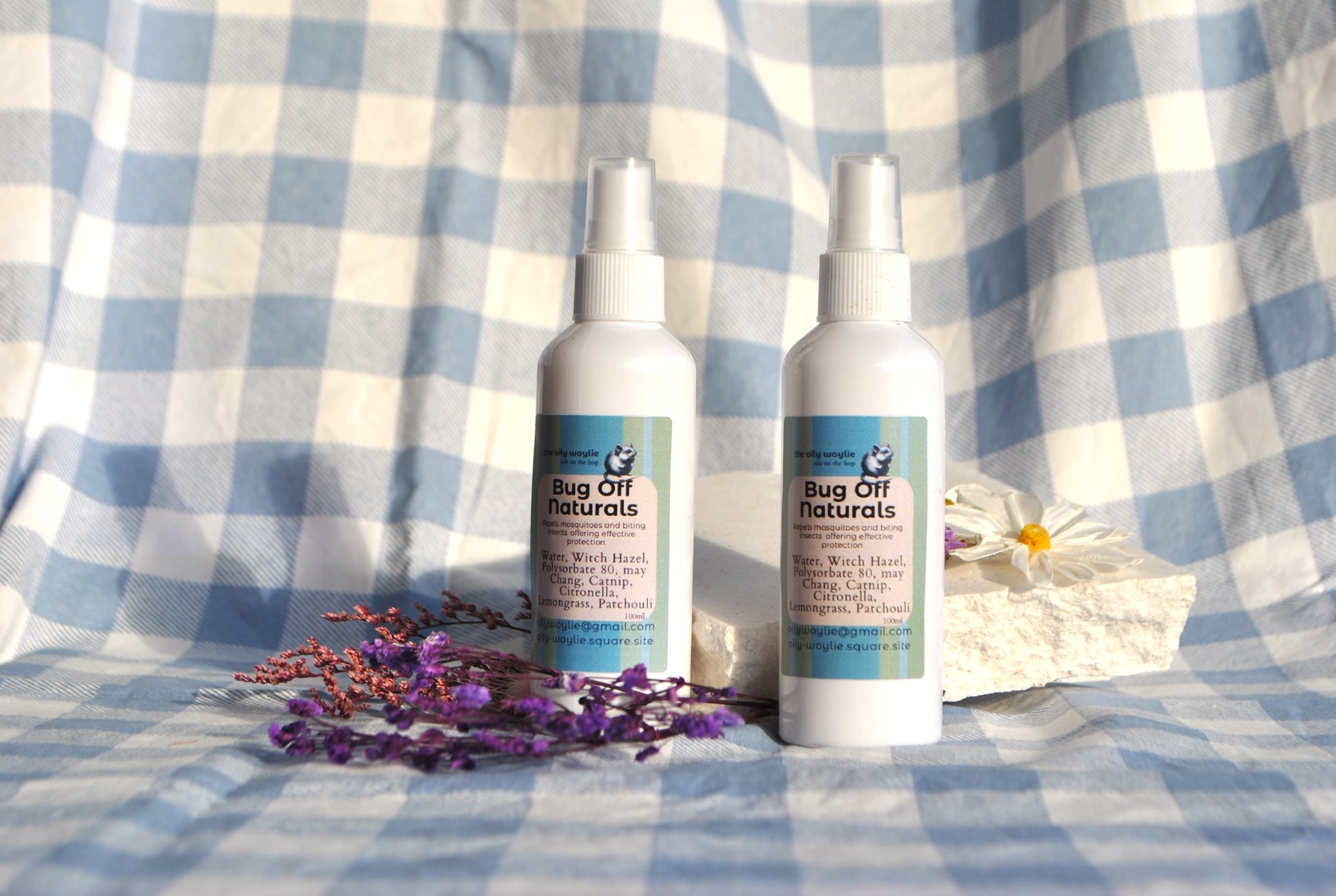 Bug Off Naturals spray bottle, natural insect repellent with essential oils on a checkered fabric background