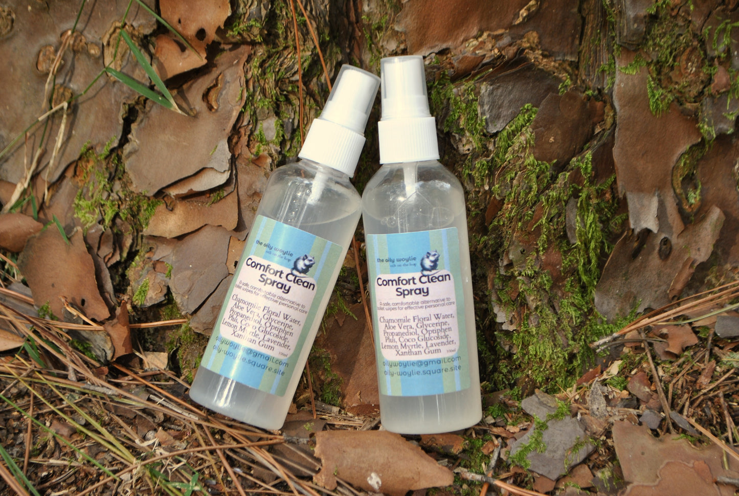 Comfort Clean Spray bottle, natural toilet spray to use instead of wet wipes on a natural background with leaves and moss.