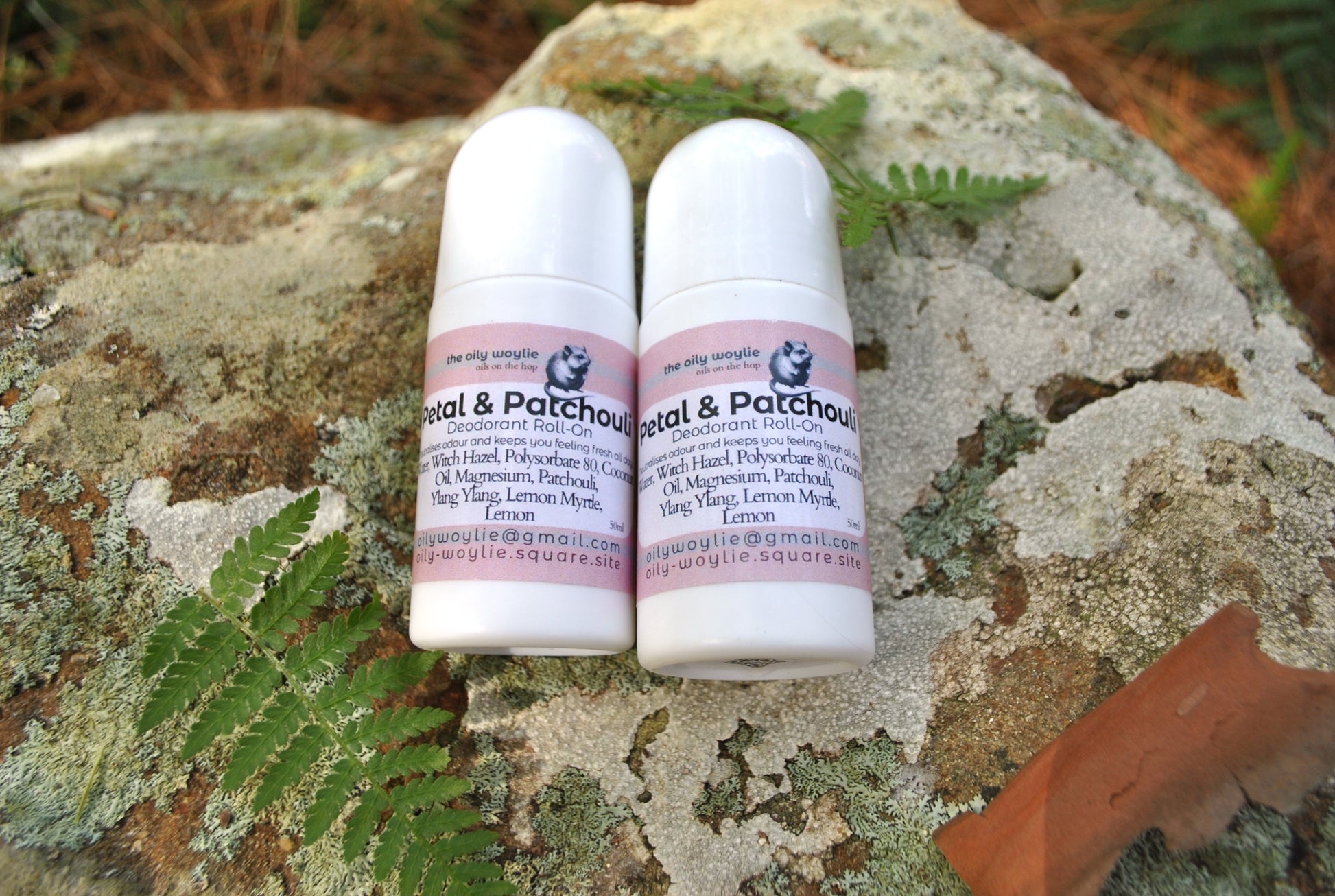 Deodorant Roll-On Petal & Patchouli bottle, natural floral deodorant on a textured stone surface.