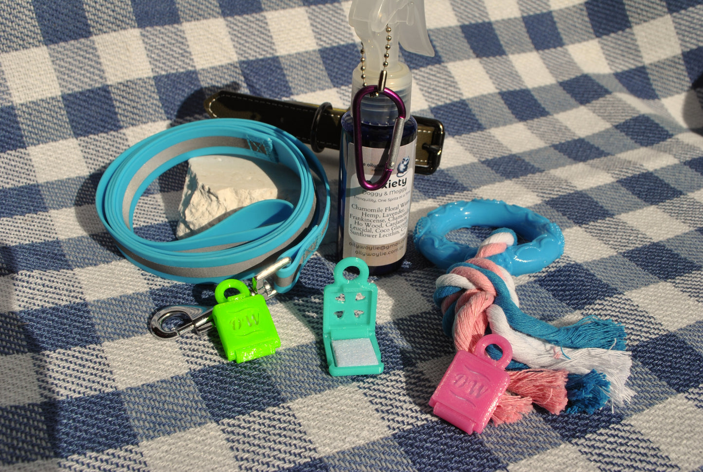 Doggy & Moggy calming lockets - small - with Anxiety Spray, natural pet support for stress and anxiety on a checkered background