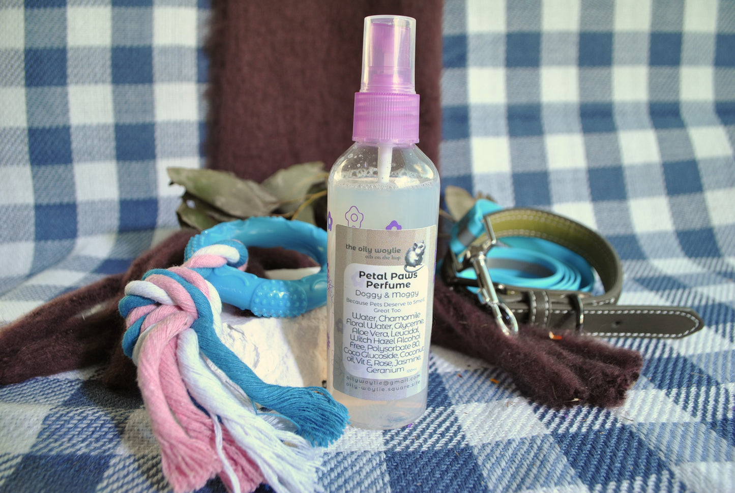 Doggy Perfume Petal Paws, natural floral spray to keep dogs smelling fresh on a checkered fabric background