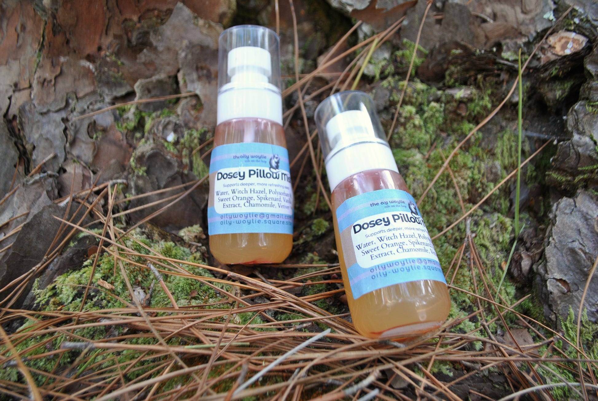 Dosey Pillow Mist spray bottle, natural essential oil mist to support relaxation and sleep on a natural background with leaves and twigs.