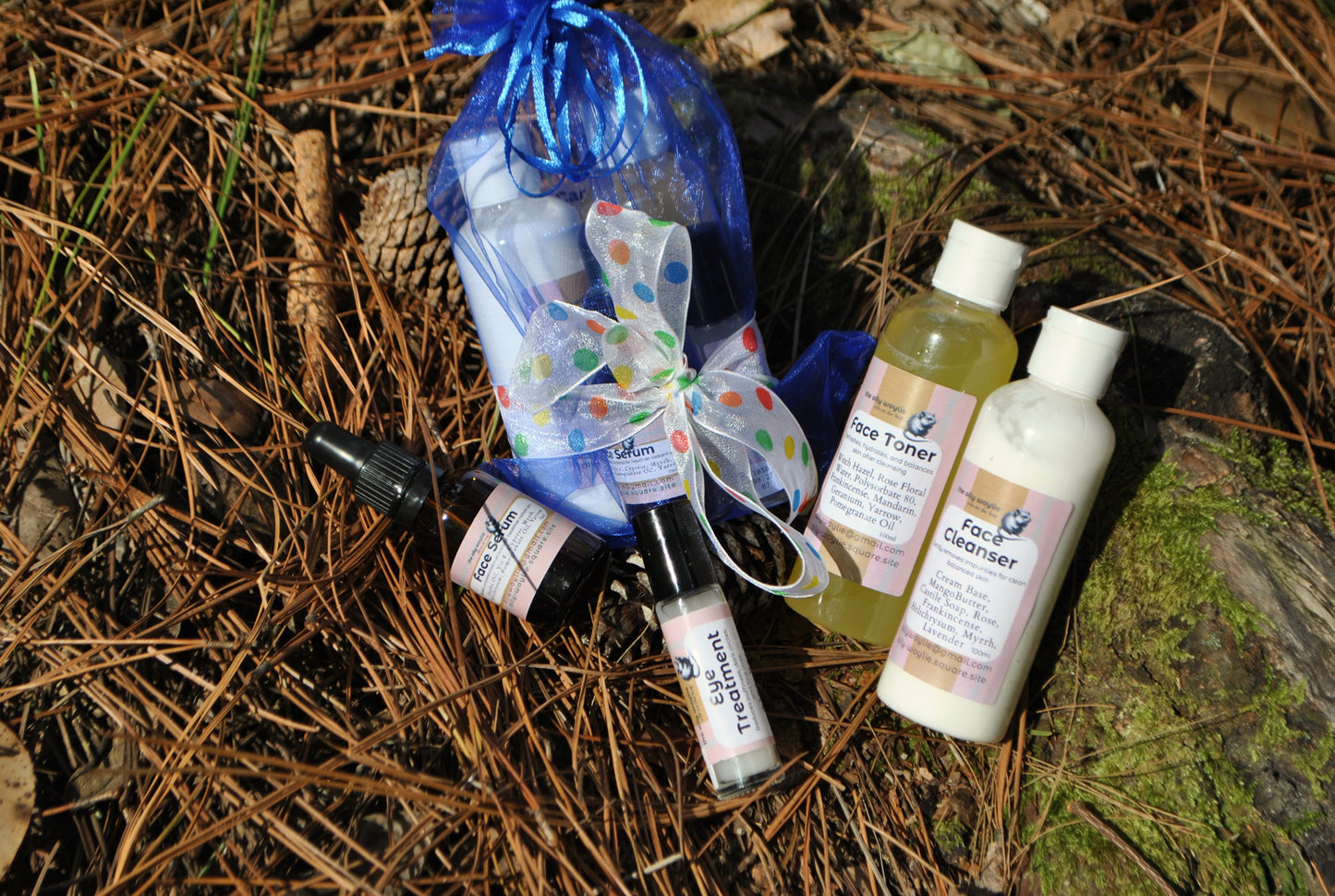 Face Care Pack set, natural skincare products bundle on a natural background with pine needles and wood.