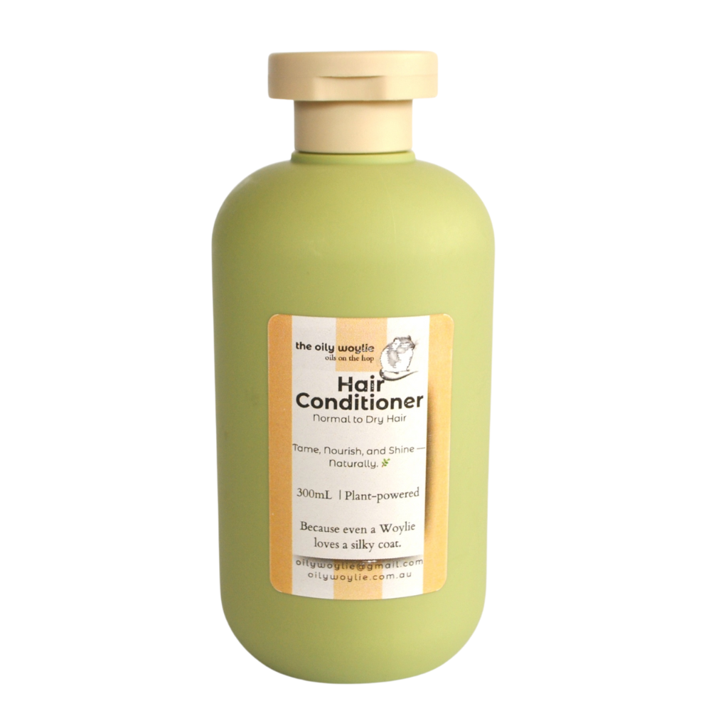 Green bottle of hair conditioner with a label on a white background. Bottle of natural hair conditioner to moisturise and smooth hair.