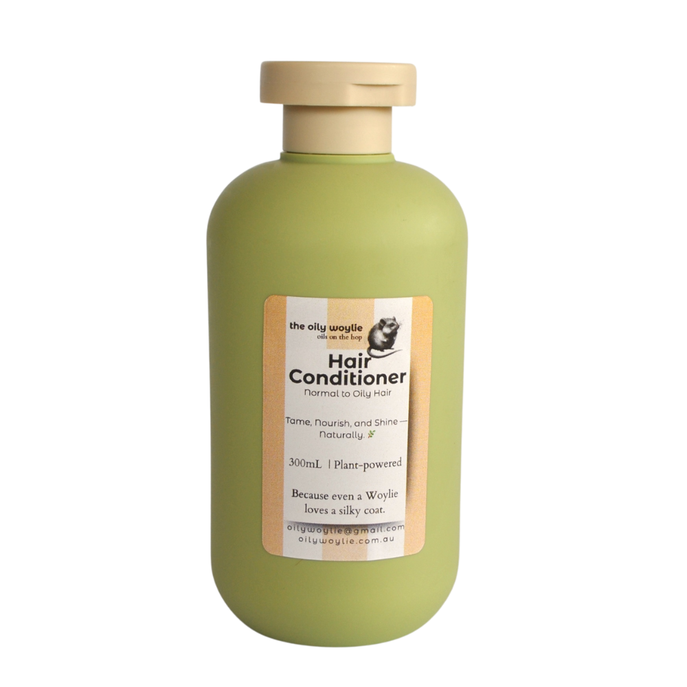 Green bottle of hair conditioner with a label on a white background. Bottle of natural hair conditioner to moisturise and smooth hair.