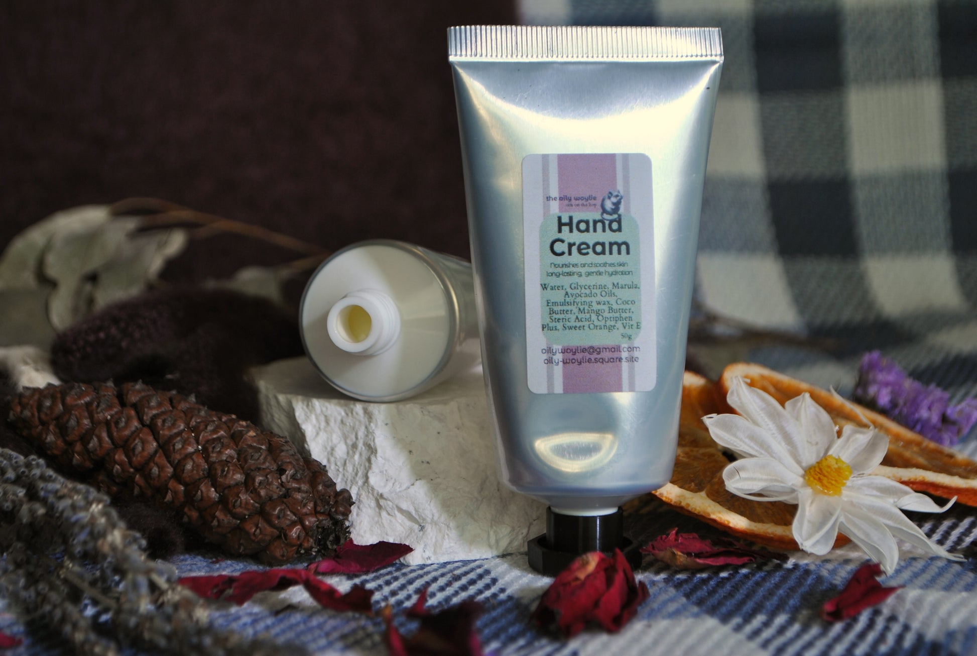 Hand Cream tube, natural moisturising cream for soft and nourished hands on a checkered fabric background with decorative elements