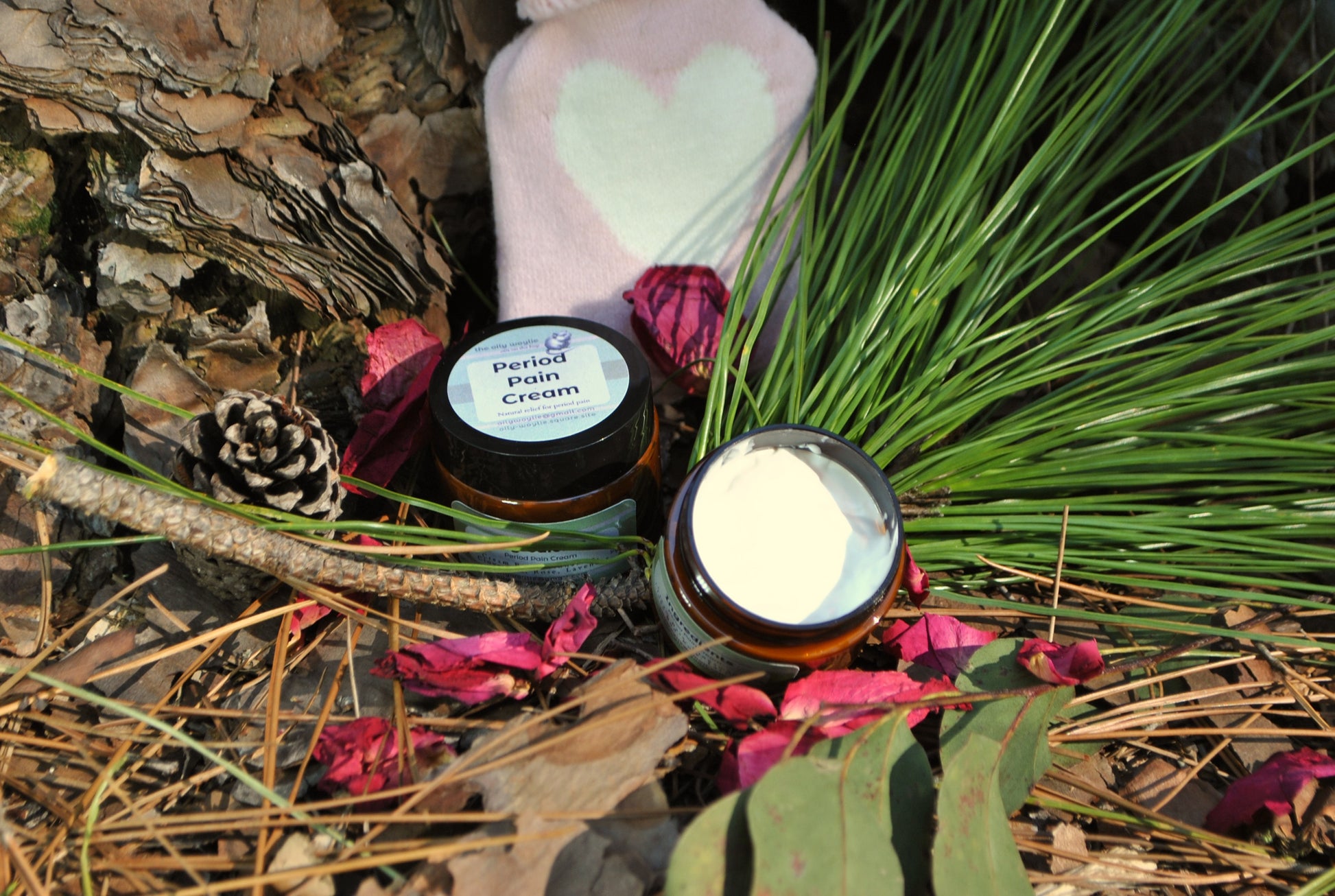 Period Pain Cream in jar, natural soothing cream for menstrual cramps and discomfort with hot water bottle