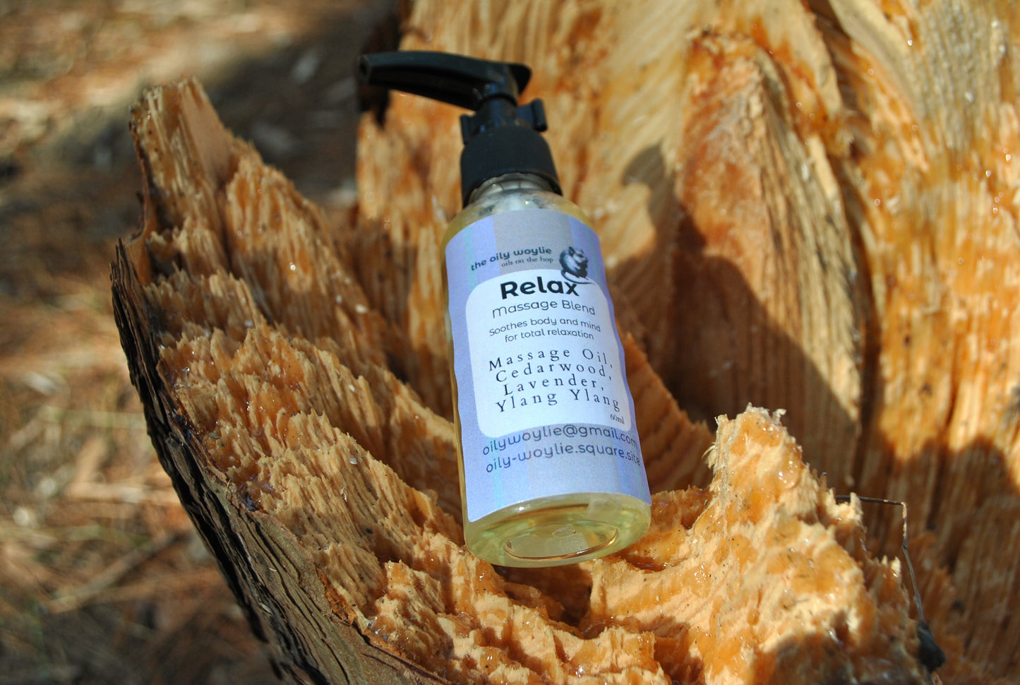 Relax Massage essential oil blend bottle, natural support for relaxation and stress relief in a tree trunk