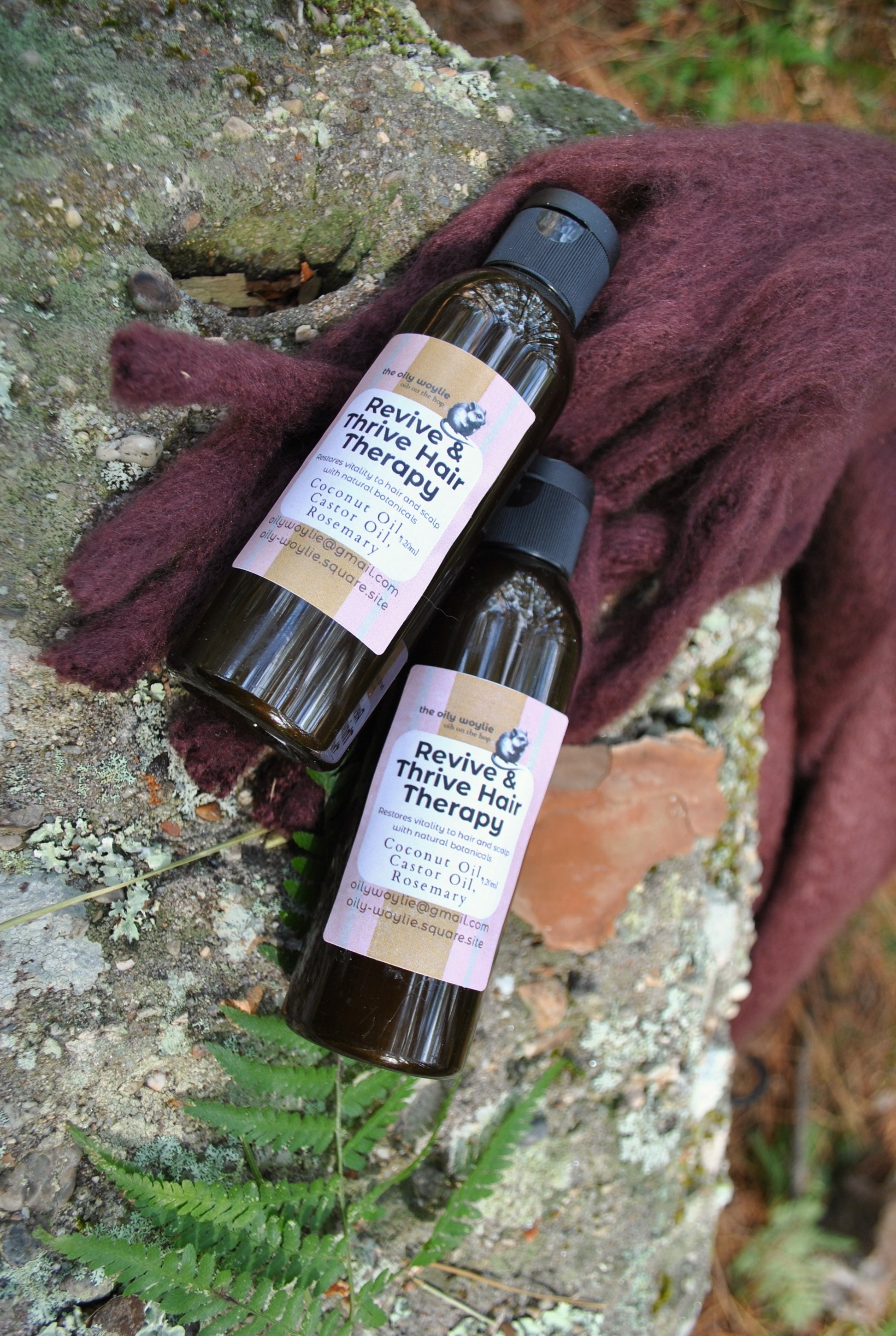 Revive & Thrive Hair Therapy bottle, natural deep hair treatment on a stone surface with a brown cloth.
