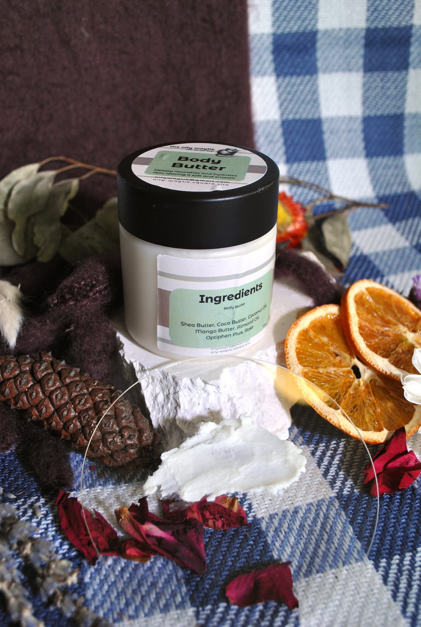 Rose Body Butter jar, natural moisturising body cream with rose scent on a checkered background