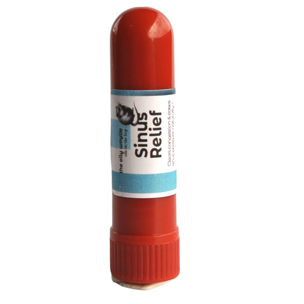 Red sinus relief stick with a white label on a white background. Portable sinus inhaler tube for quick aromatic relief of blocked sinuses.