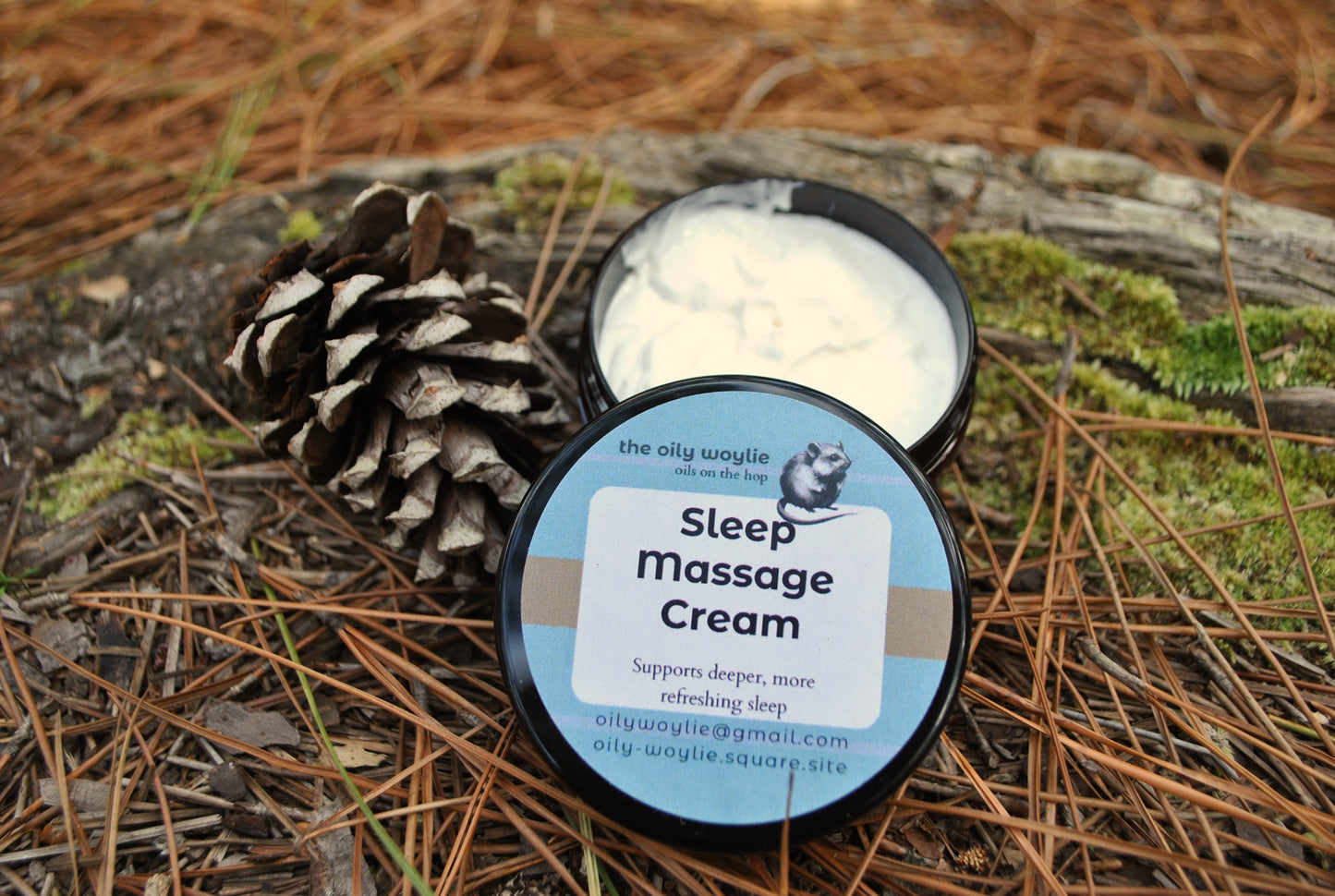 Sleep Massage Cream jar, natural cream with essential oils to support relaxation and sleep on a natural background with pine cone and leaves