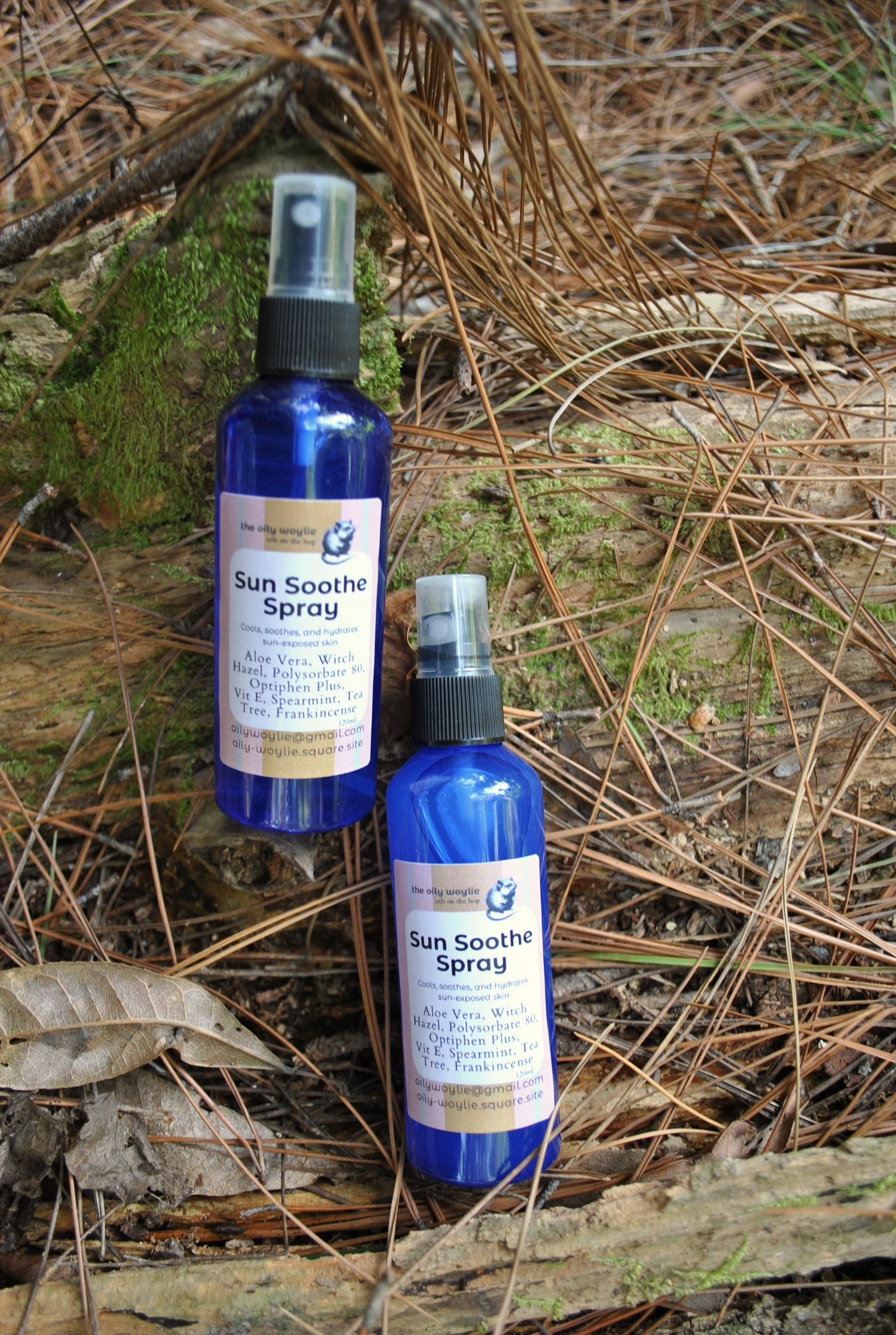 Sun Soothe Spray bottle, natural after-sun skin spray on a natural background with leaves and twigs.