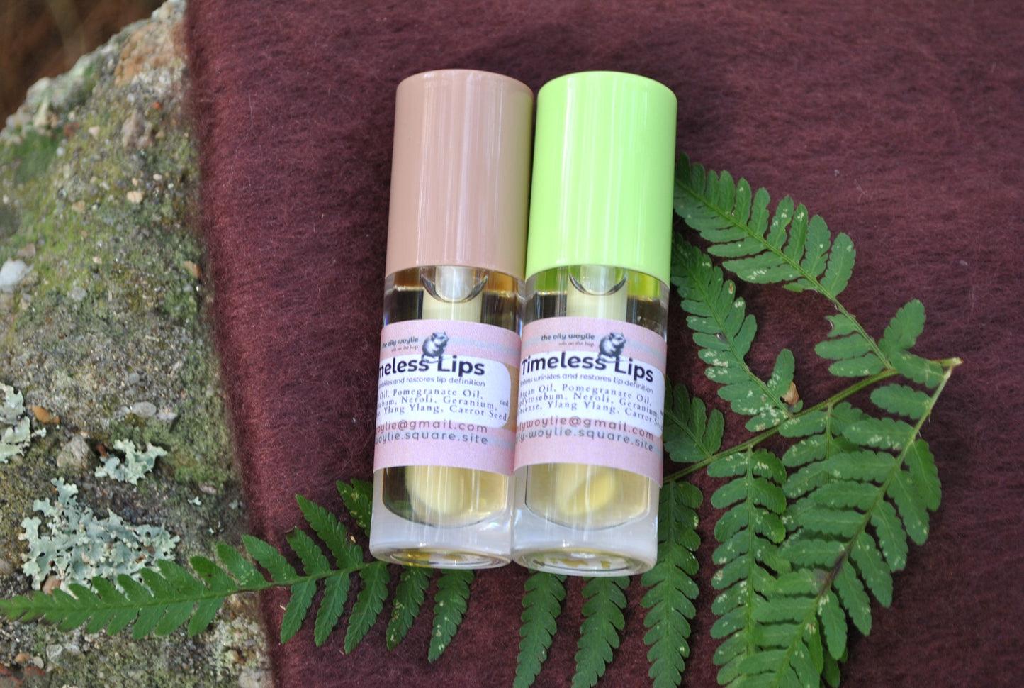 Timeless Lips treatment oil bottle, natural oil to help reduce the appearance of fine lines around lips on a textured surface with green leaves.