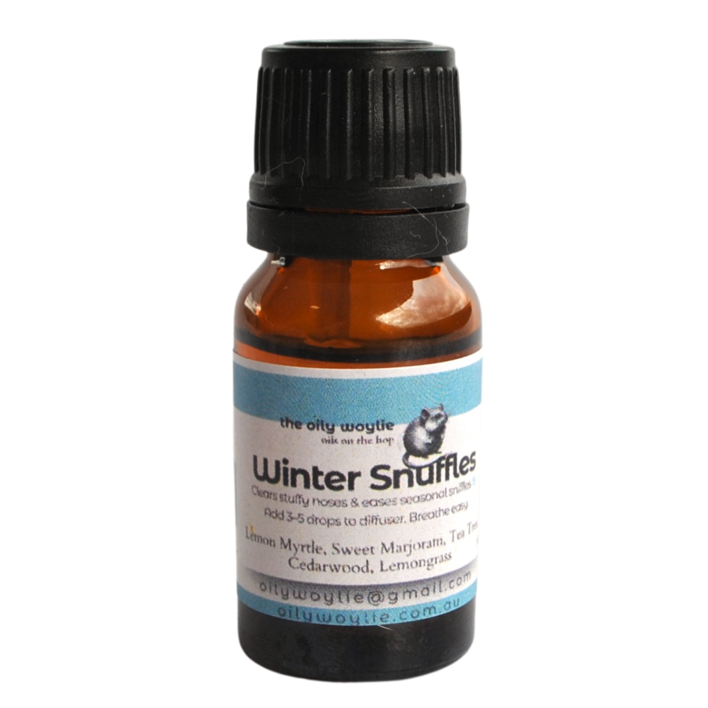 Bottle of 'Winter Snuffles' essential oil blend with a black cap on a white background. Winter seasonal diffuser blend to support breathing and comfort.
Essential oil diffuser blend for easing congestion during winter months.
