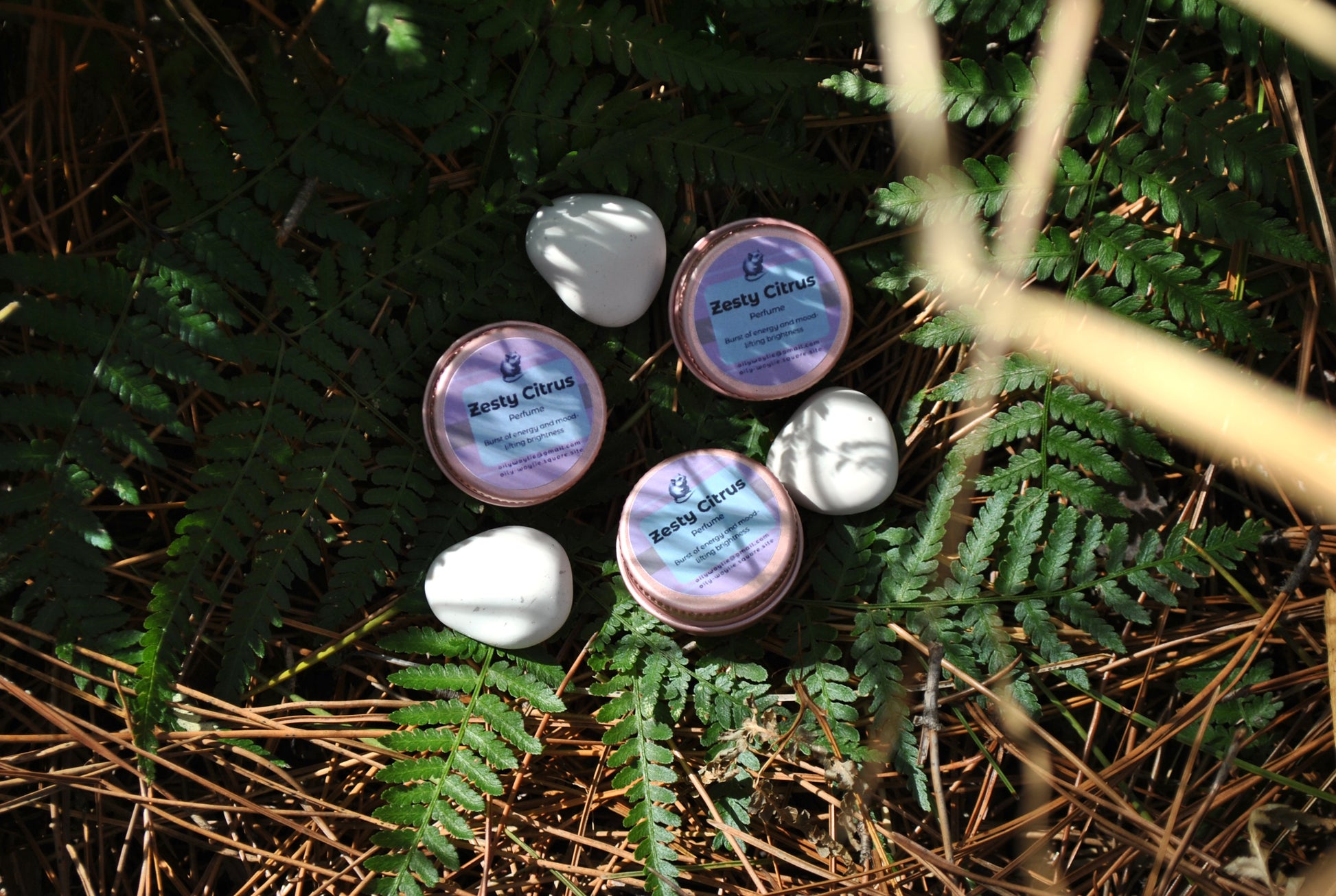 Zesty Citrus Perfume, natural refreshing fragrance with citrus scent on a natural background with ferns and twigs